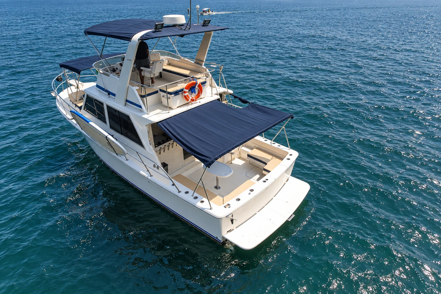 Aerial stern view of the Uniflite and its shaded fishing cockpit