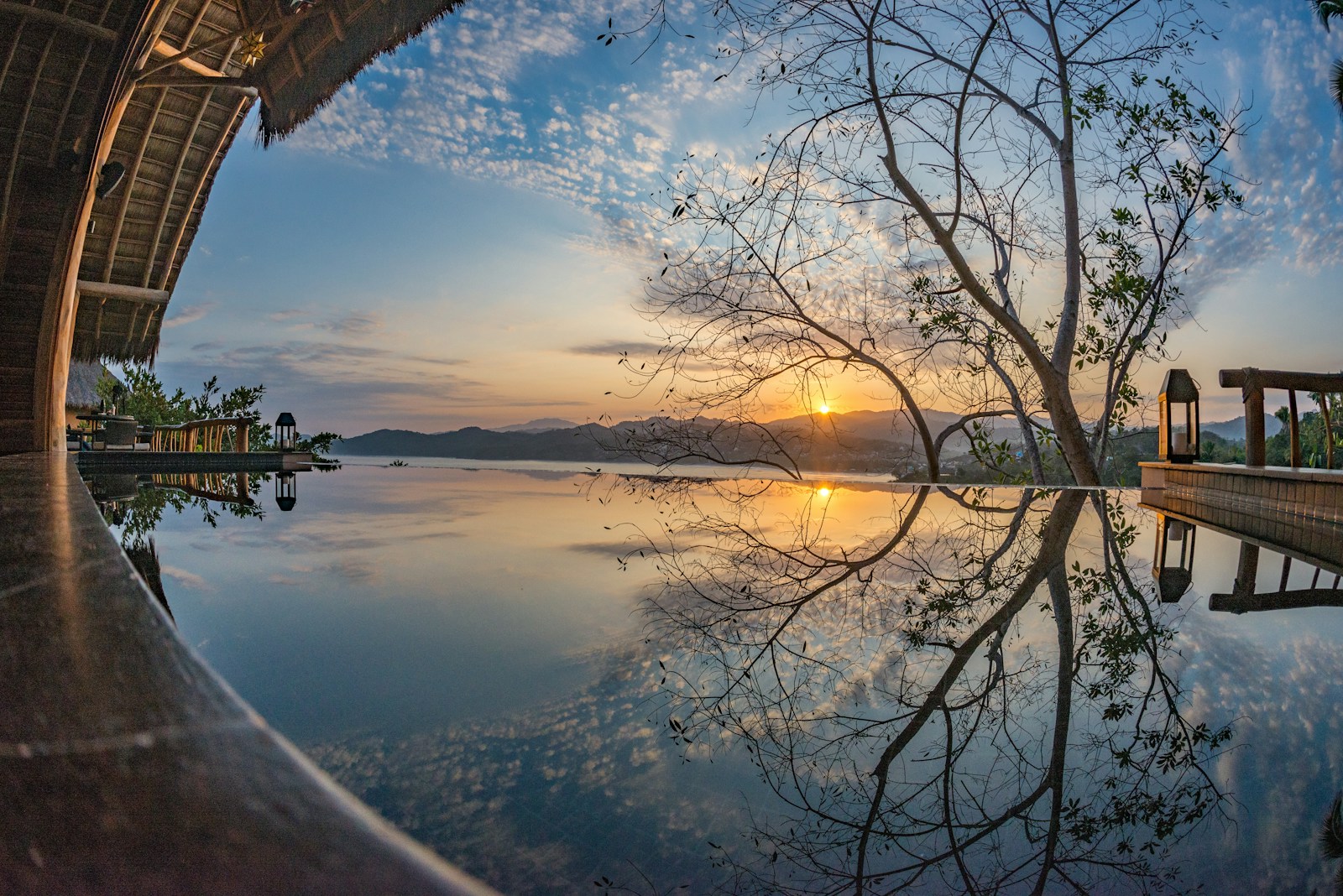 A private pool and palm-thatched terrace overlooking the hills of Sayulita